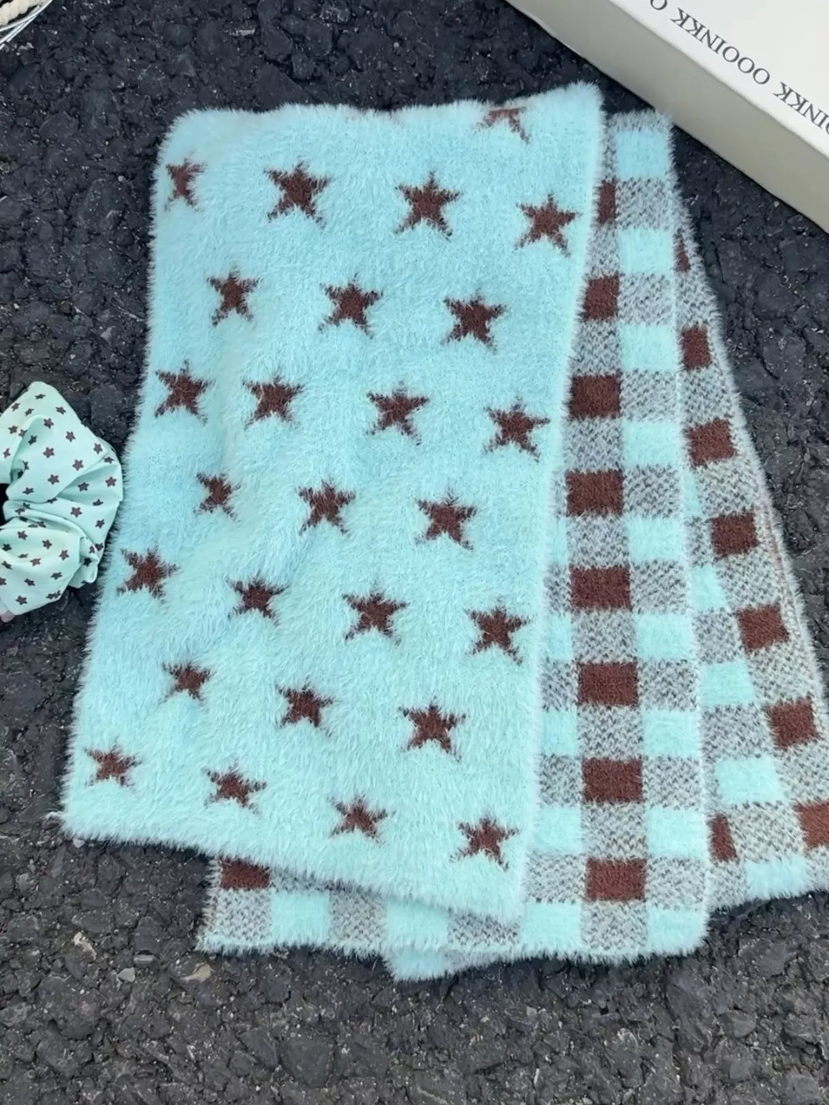 Unisex Star and Check Knit Scarf — folded mint scarf showing repeated dark stars