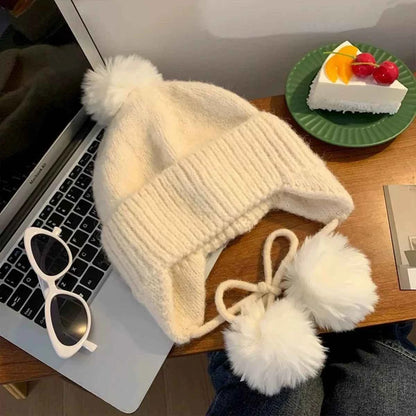 Beige pom pom ear flap knitted beanie