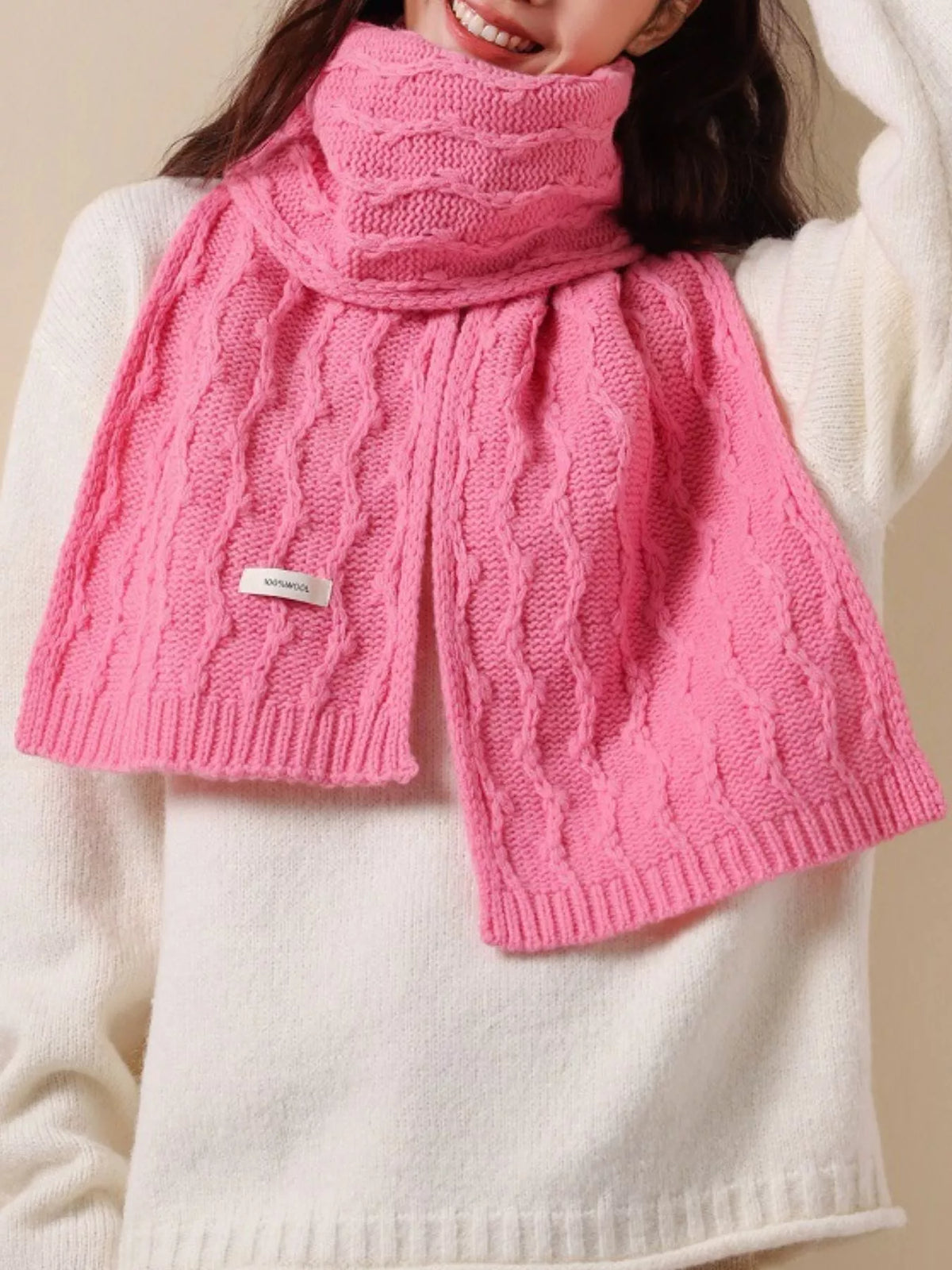 Unisex Wool Cozy Cable Knit Scarf — pink scarf worn with a cream sweater