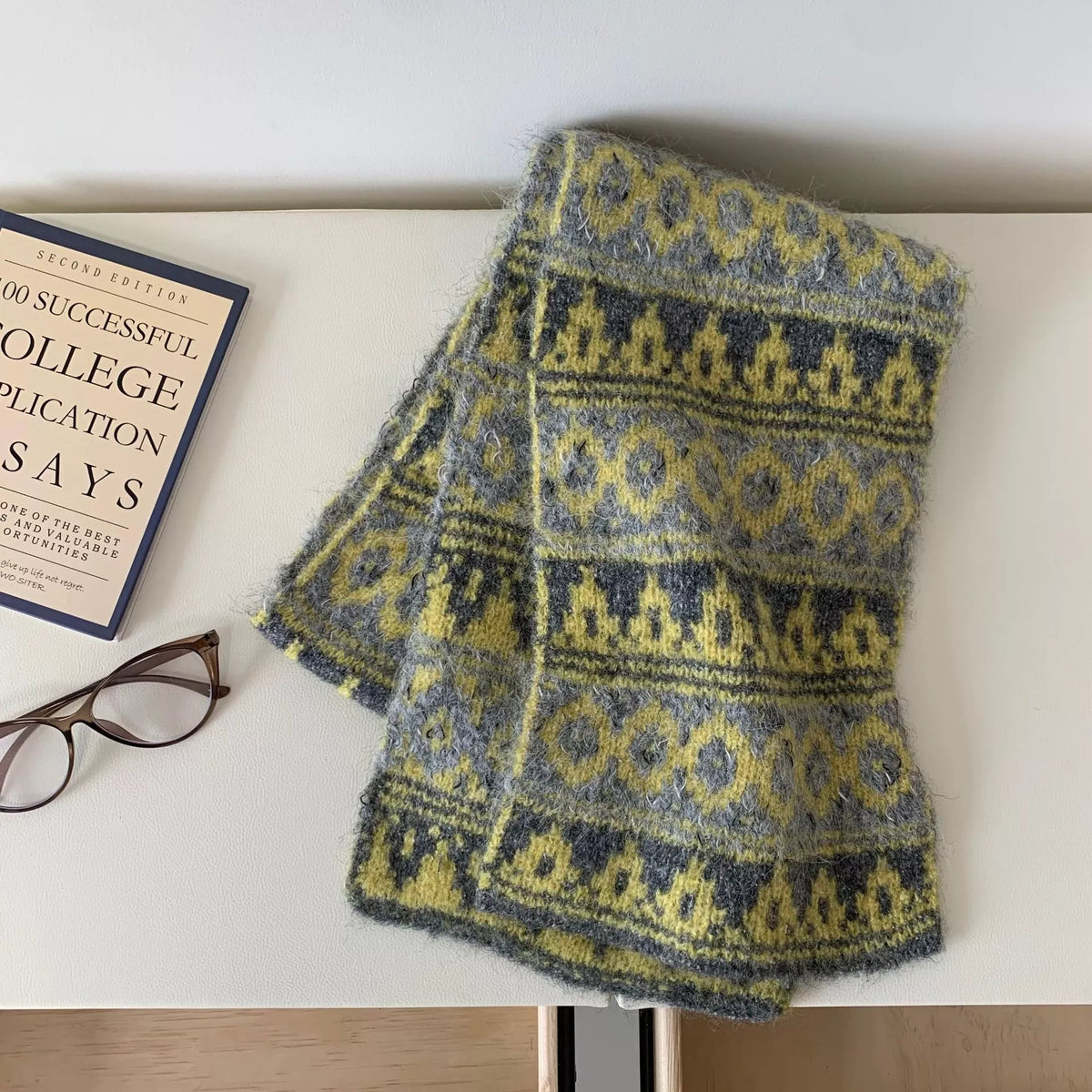 Unisex Vintage Knitted Pattern Warm Scarf — blue and yellow motif scarf folded on a magazine