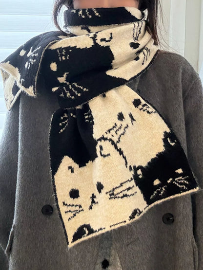 Unisex Allover Cat Knit Scarf — black cat patterned scarf worn over dark clothing