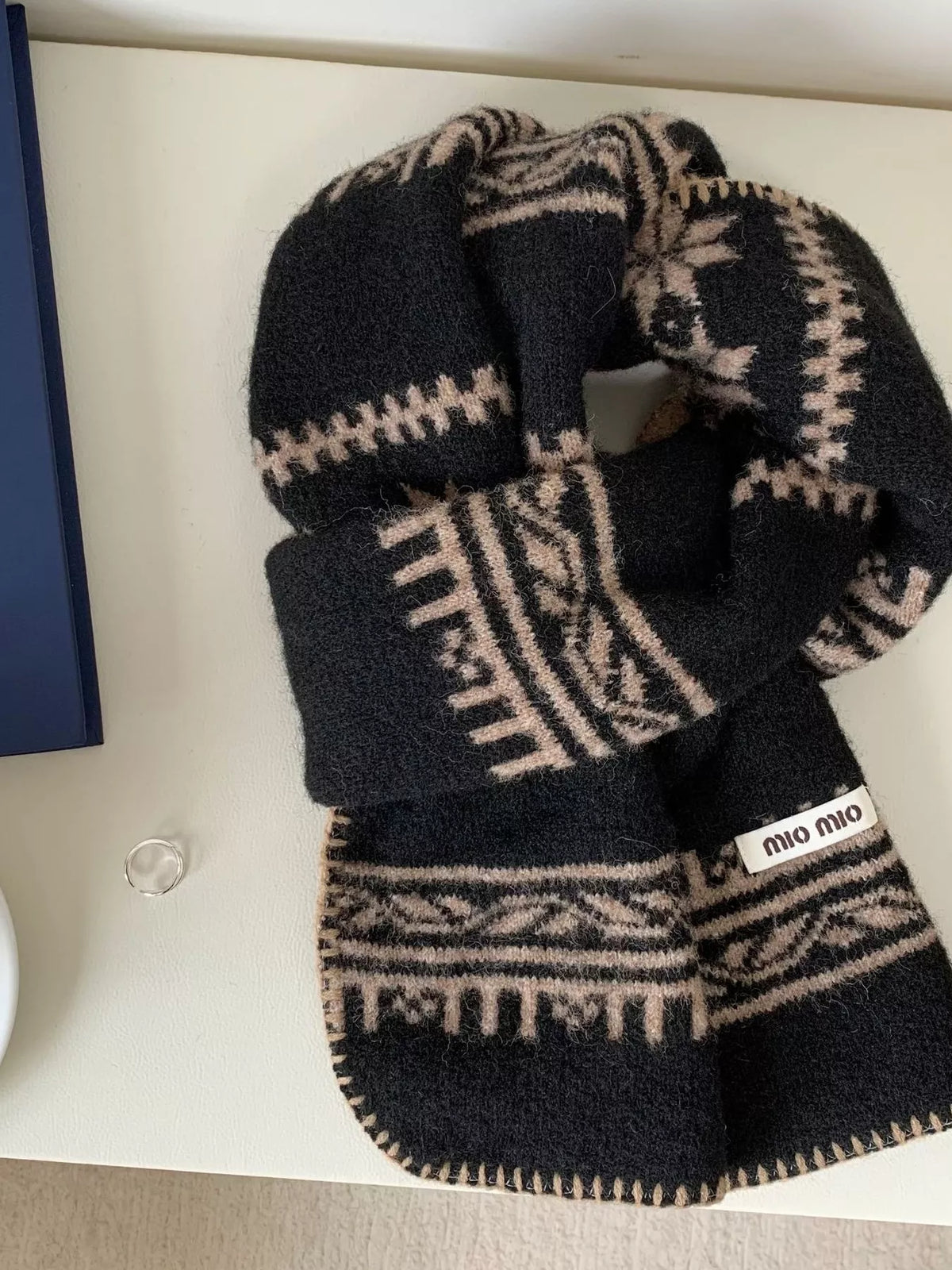 Unisex Vintage Pattern Knitted Scarf — black scarf with pale vintage-inspired geometric rows