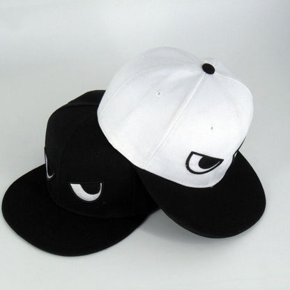 White and black angry-eyes cap front view