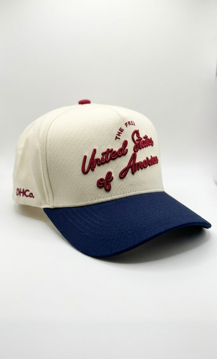 Opposite angled view of the Destination Hat Co. U.S.A. script cap showing the red lettering