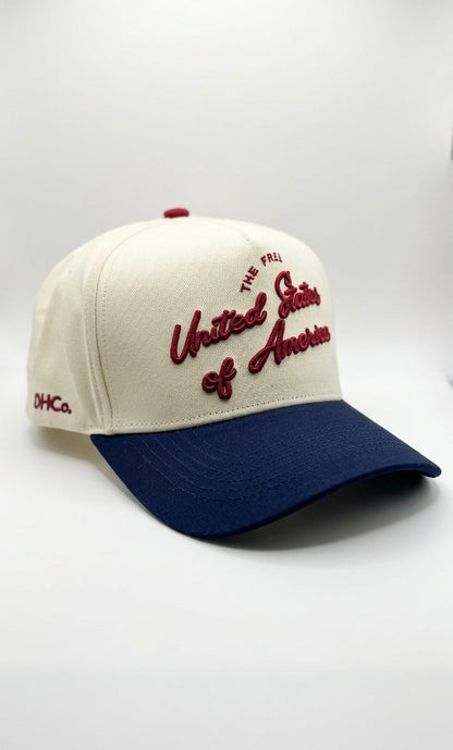 Opposite angled view of the Destination Hat Co. U.S.A. script cap showing the red lettering