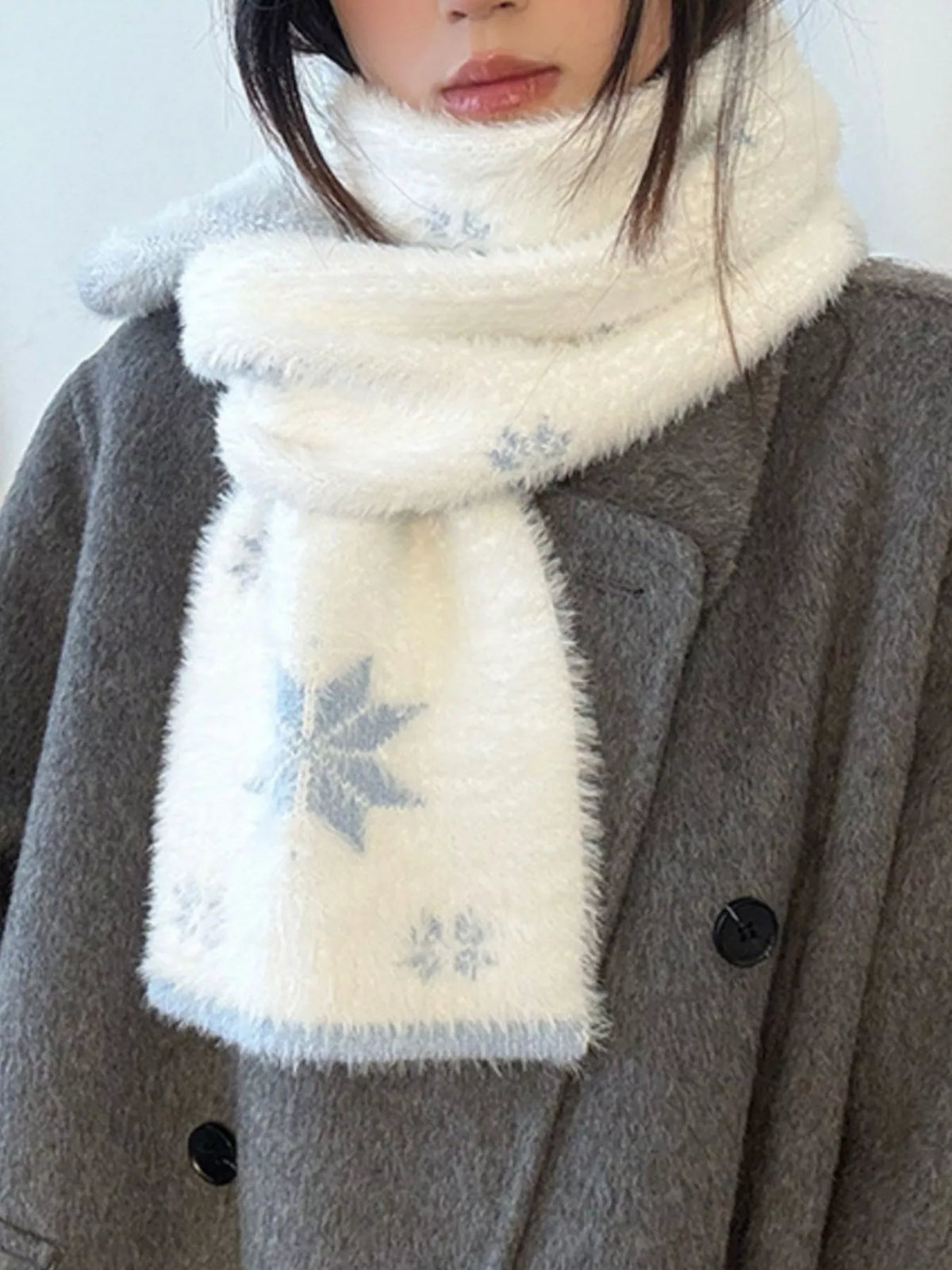 Unisex Snowflake Plush Knit Scarf — pale scarf with blue snowflake details at the neckline