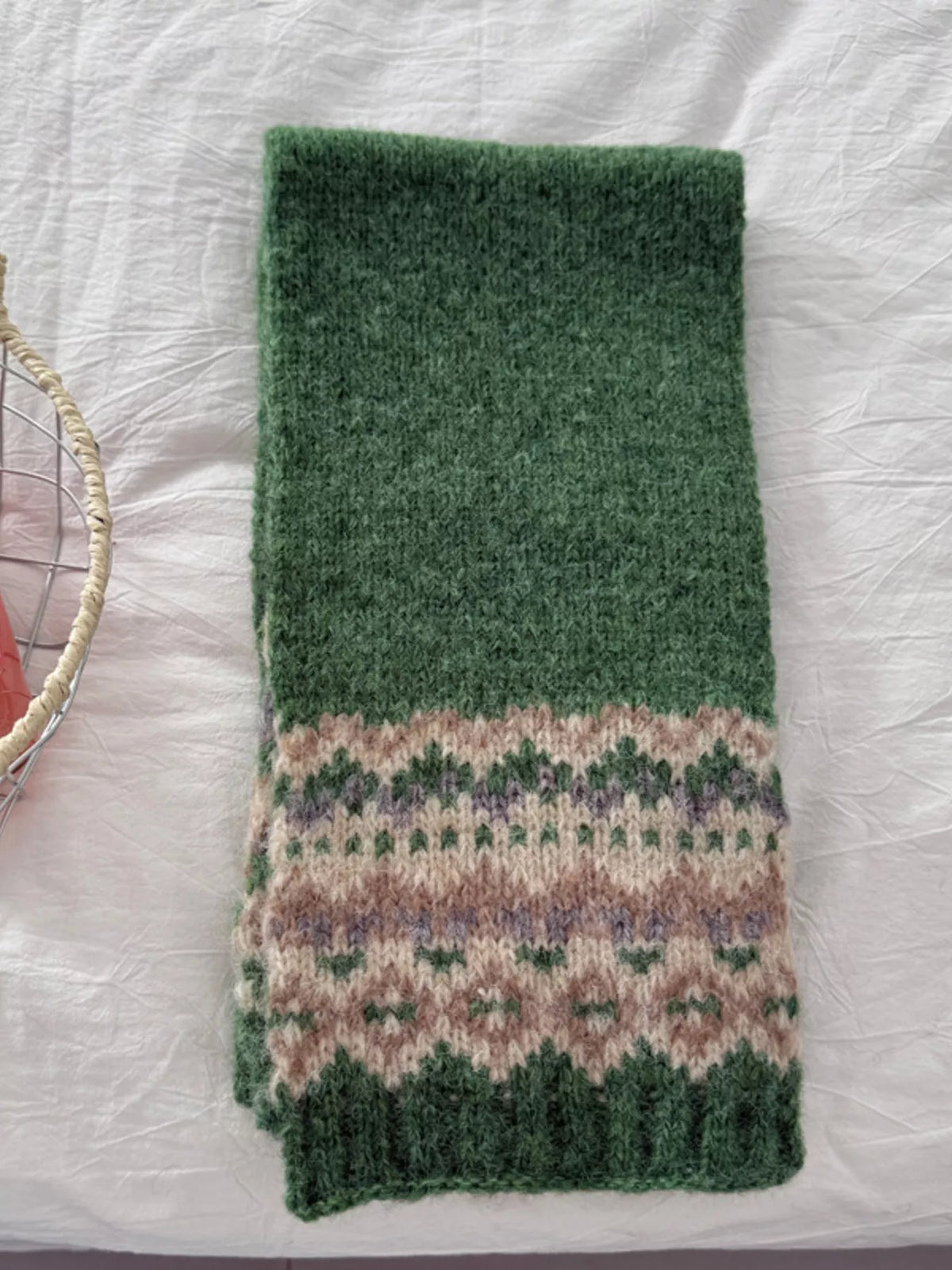 Unisex Nordic Motif Knit Scarf — green patterned scarf laid long on a pale surface