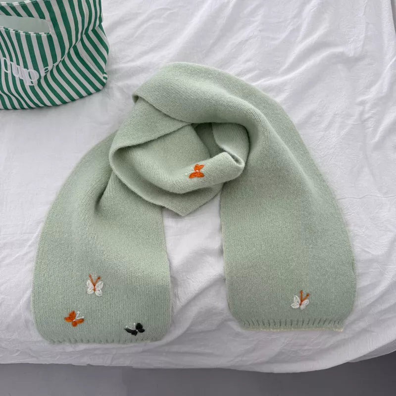 Unisex Butterfly Embroidered Scarf — green butterfly scarf gathered on a pale surface