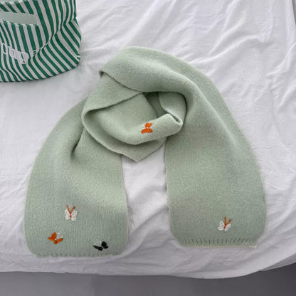 Unisex Butterfly Embroidered Scarf — green butterfly scarf gathered on a pale surface