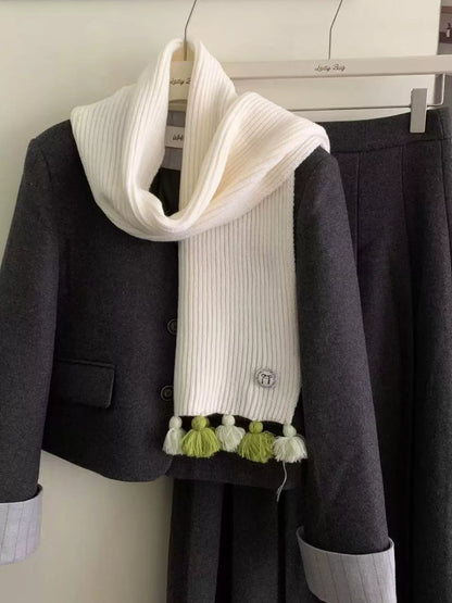 Unisex Ribbed Knit Tassel Scarf — cream ribbed scarf worn with green tassels visible