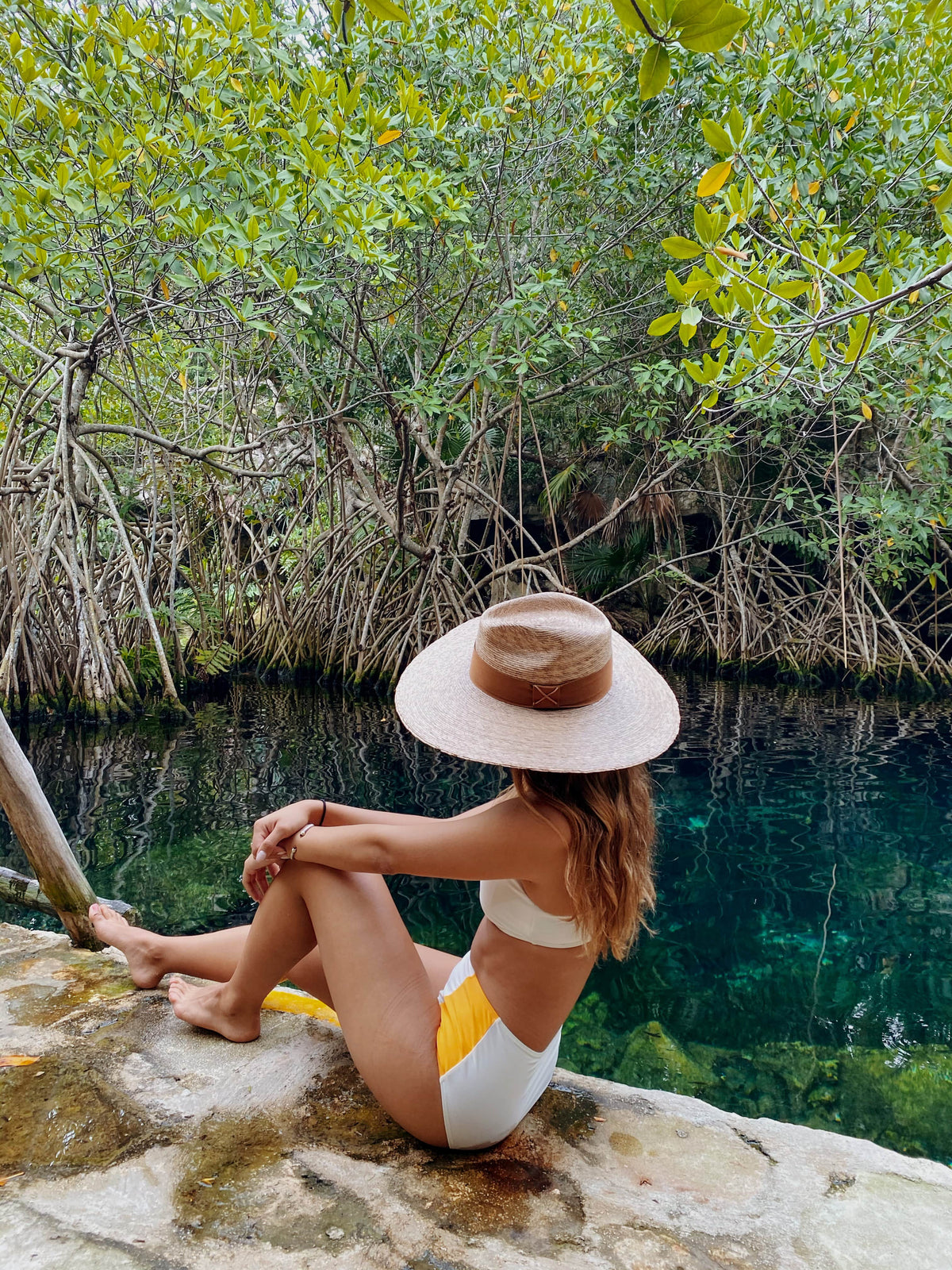 ASN Hats Riviera natural fedora hat, worn by a model seated near the water