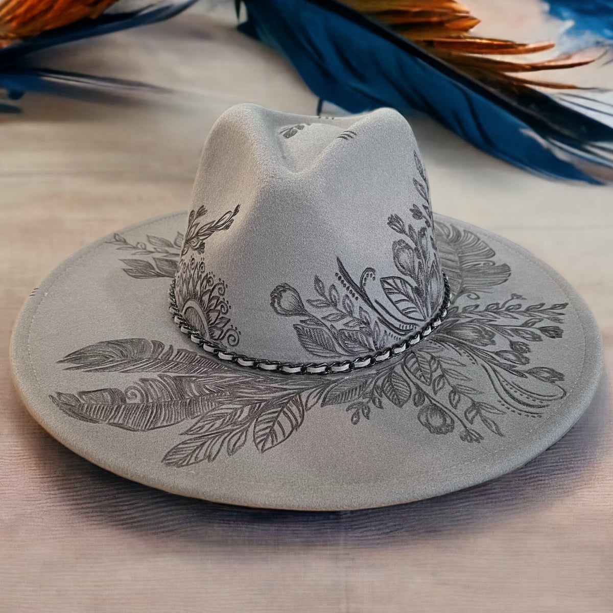 Grey Piper Topknot fedora with burned botanical artwork across its wide brim