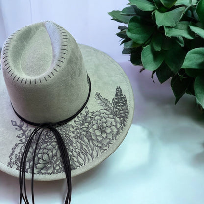 Rear view of the sage green Jade hat showing artwork around the crown