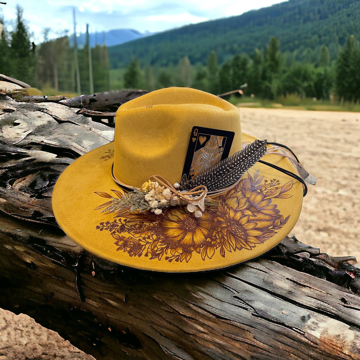 Front view of the Aurelia hat showing floral pyrography across the wide brim