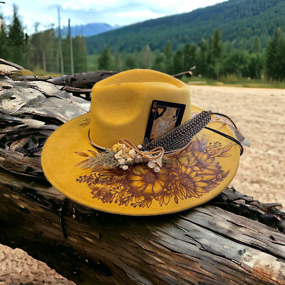 Front view of the Aurelia hat showing floral pyrography across the wide brim