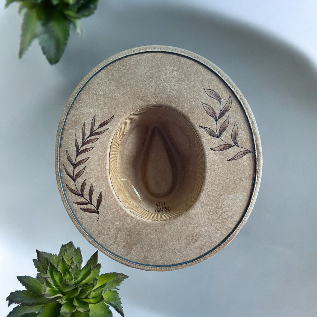 Underside of the Whiteleaf hat showing the inner band and burned leaf design