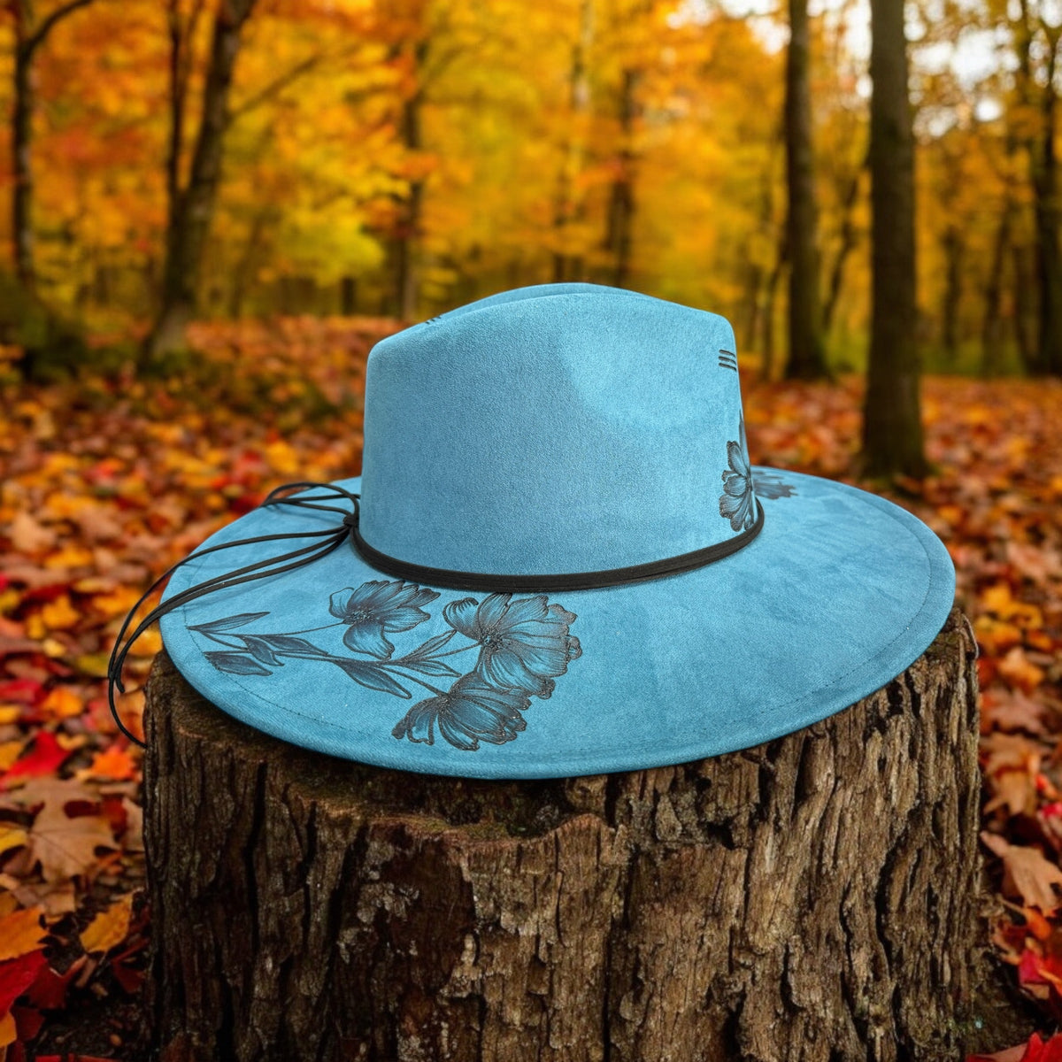 Opposite side of the blue Native Petals hat showing leaf and flower details