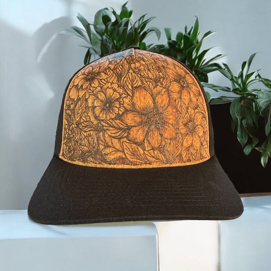 Piper Awake cork trucker hat with layered burned flowers and a black curved bill
