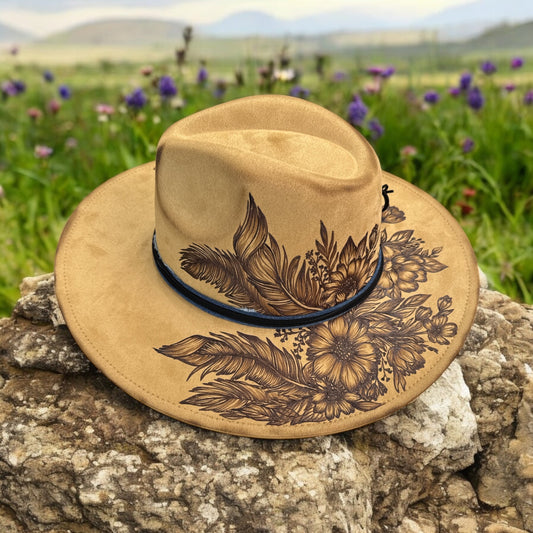 Angled view of the Feather Play hat showing floral pyrography and the decorative band