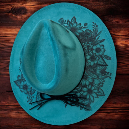 Overhead view of the teal Piper hat showing the shaped crown and floral brim