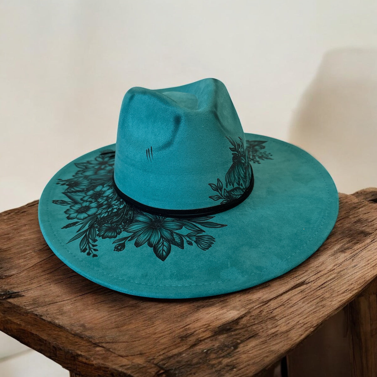 Piper Hat Co. Wildflowers in Teal wide-brim hat with dark burned floral artwork