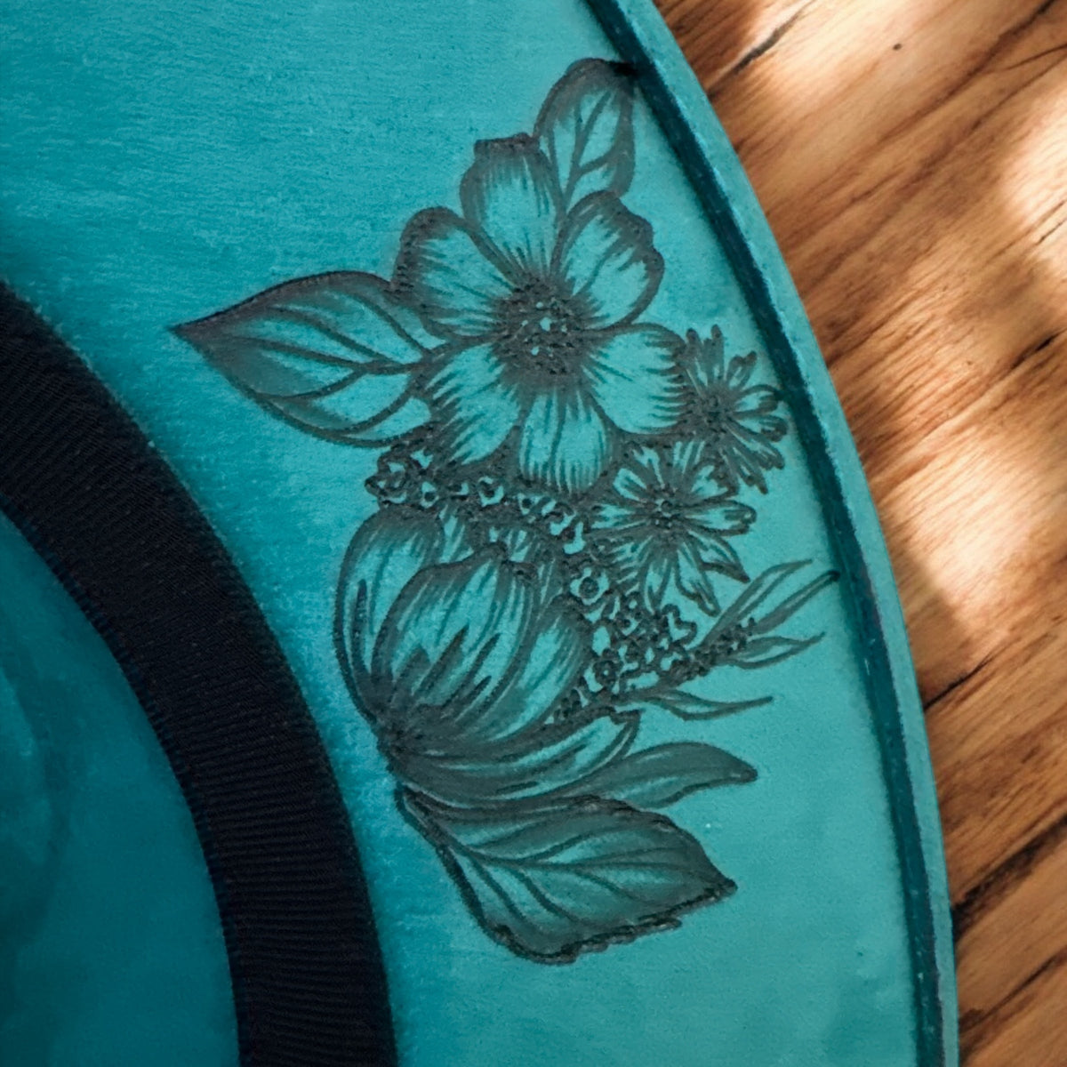 Detail of the burned wildflowers on the teal hat brim