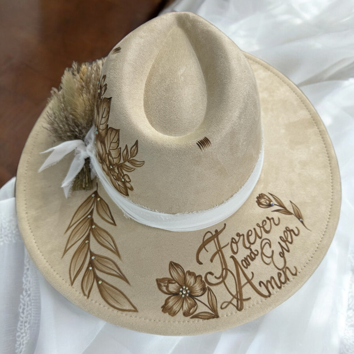 Overhead view of the Forever & Ever hat showing floral artwork and decorative lettering
