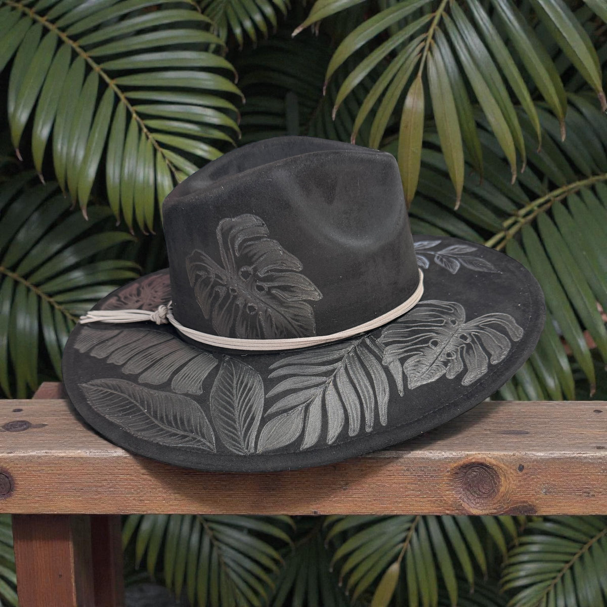Side view of the black High Definition fedora on a wooden table