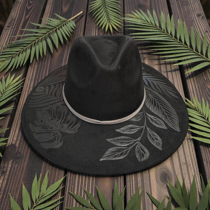 Black High Definition fedora with pale botanical artwork, front angled view
