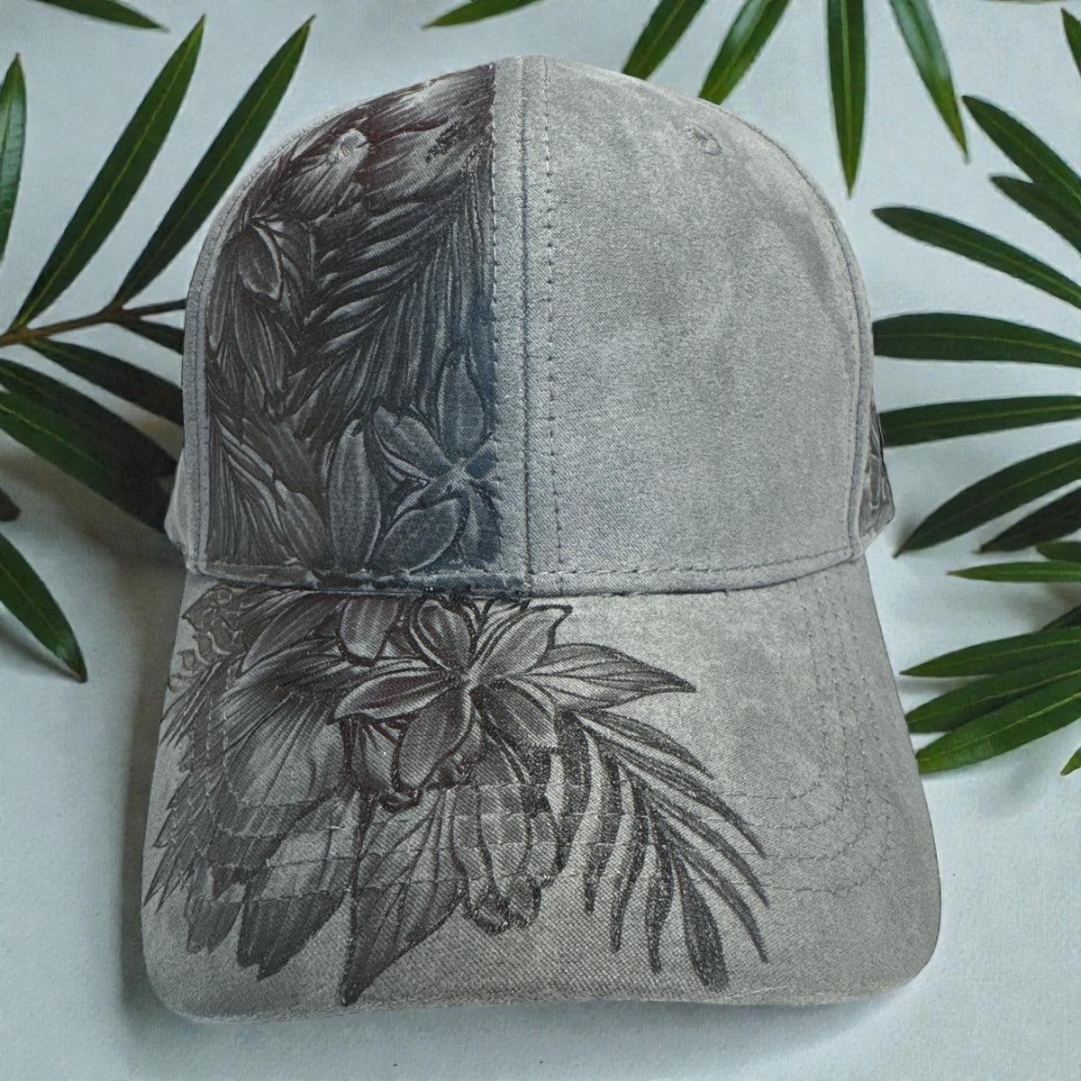 Dark grey Full Blooms cap with tropical pyrography, close front view