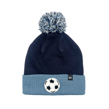 Rey To Z navy and blue pom-pom hat reference photo showing a soccer-ball patch
