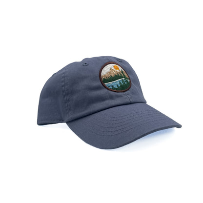 Angled view of Rey To Z Mountain Baseball Hat in Dusty Blue showing the curved bill and front design