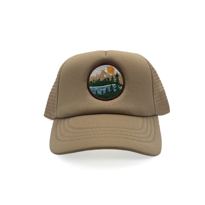 Front view of Rey To Z Mountain Trucker Hat in Khaki showing round mountain landscape front patch