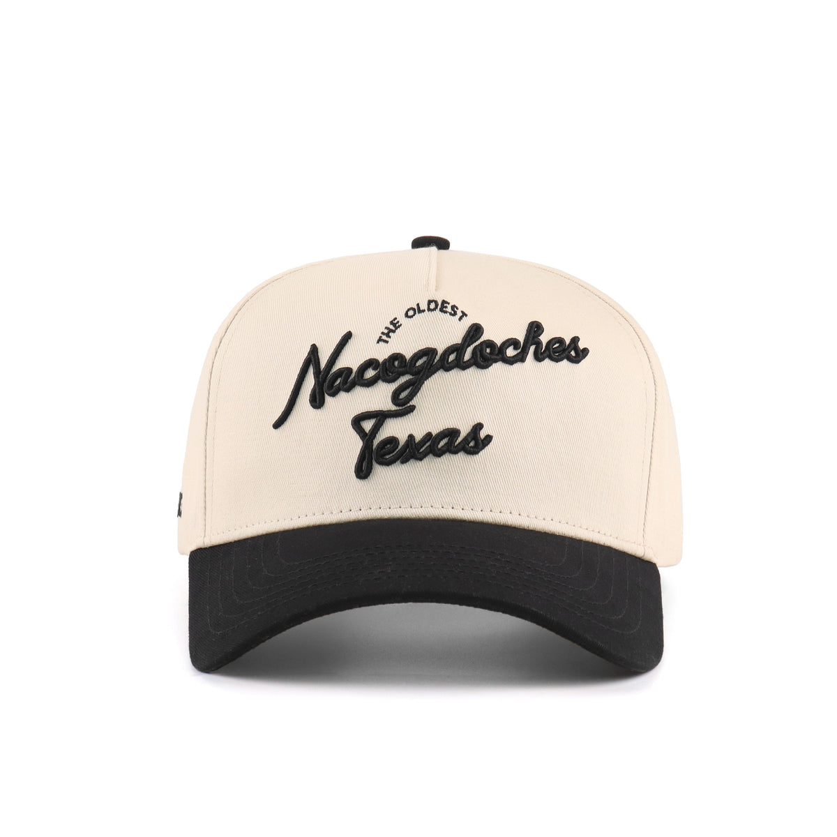 Front view of the Destination Hat Co. Nacogdoches script cap with black embroidery