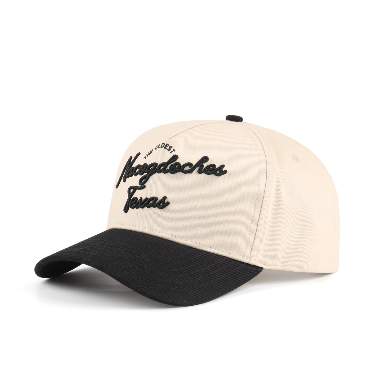 Opposite angled view of the Destination Hat Co. Nacogdoches script cap showing the black lettering
