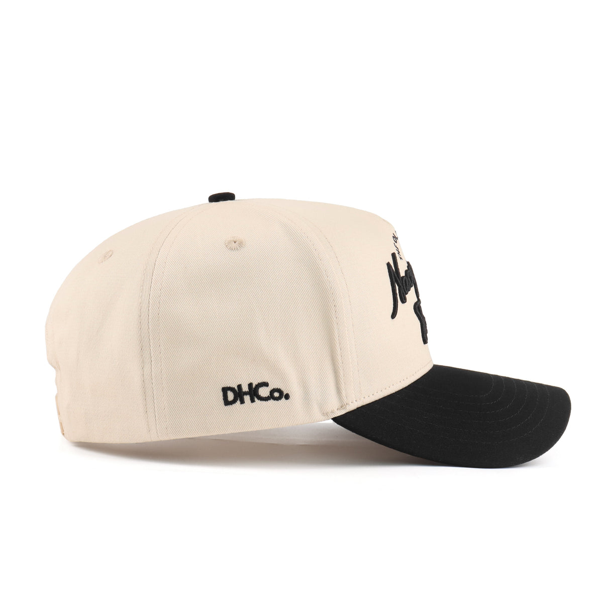 Side profile of the Destination Hat Co. Nacogdoches script cap showing the curved bill and side logo