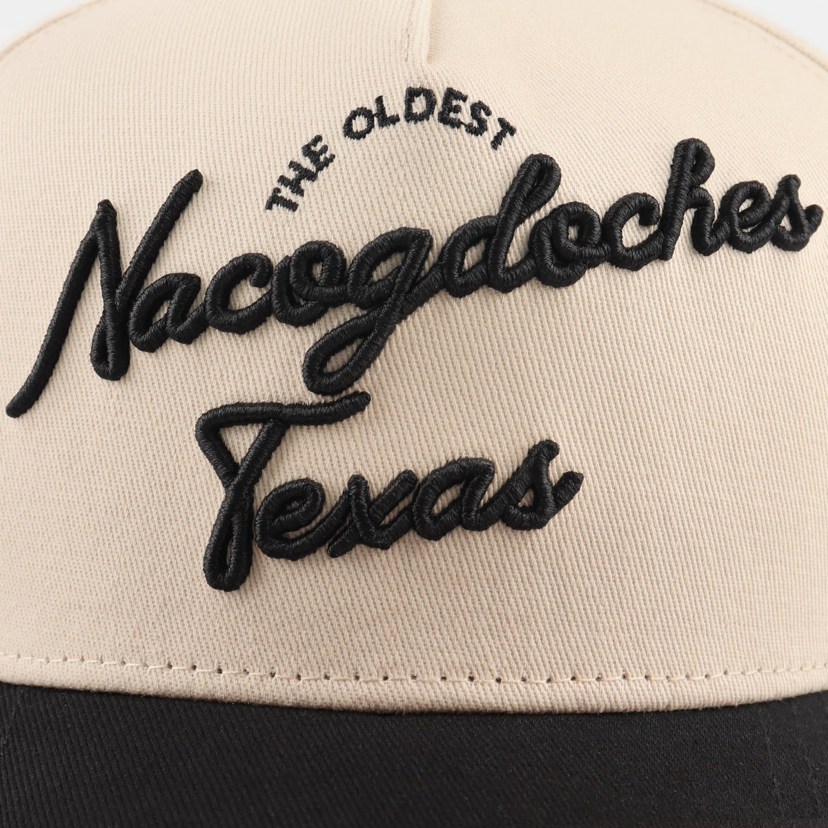 Close-up of the black Nacogdoches embroidery on the beige crown