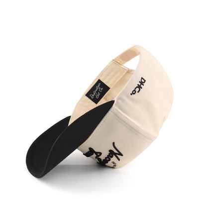 Interior view of the Destination Hat Co. Nacogdoches script cap showing the inner band and underside of the bill