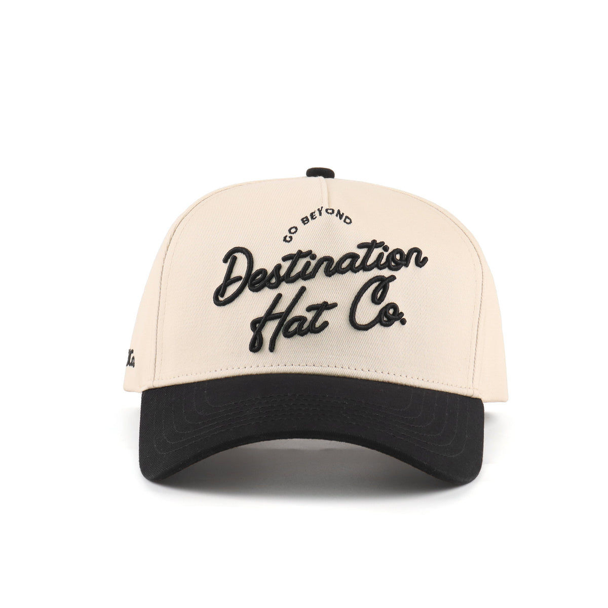 Front view of the Destination Hat Co. Destination script cap with black embroidery
