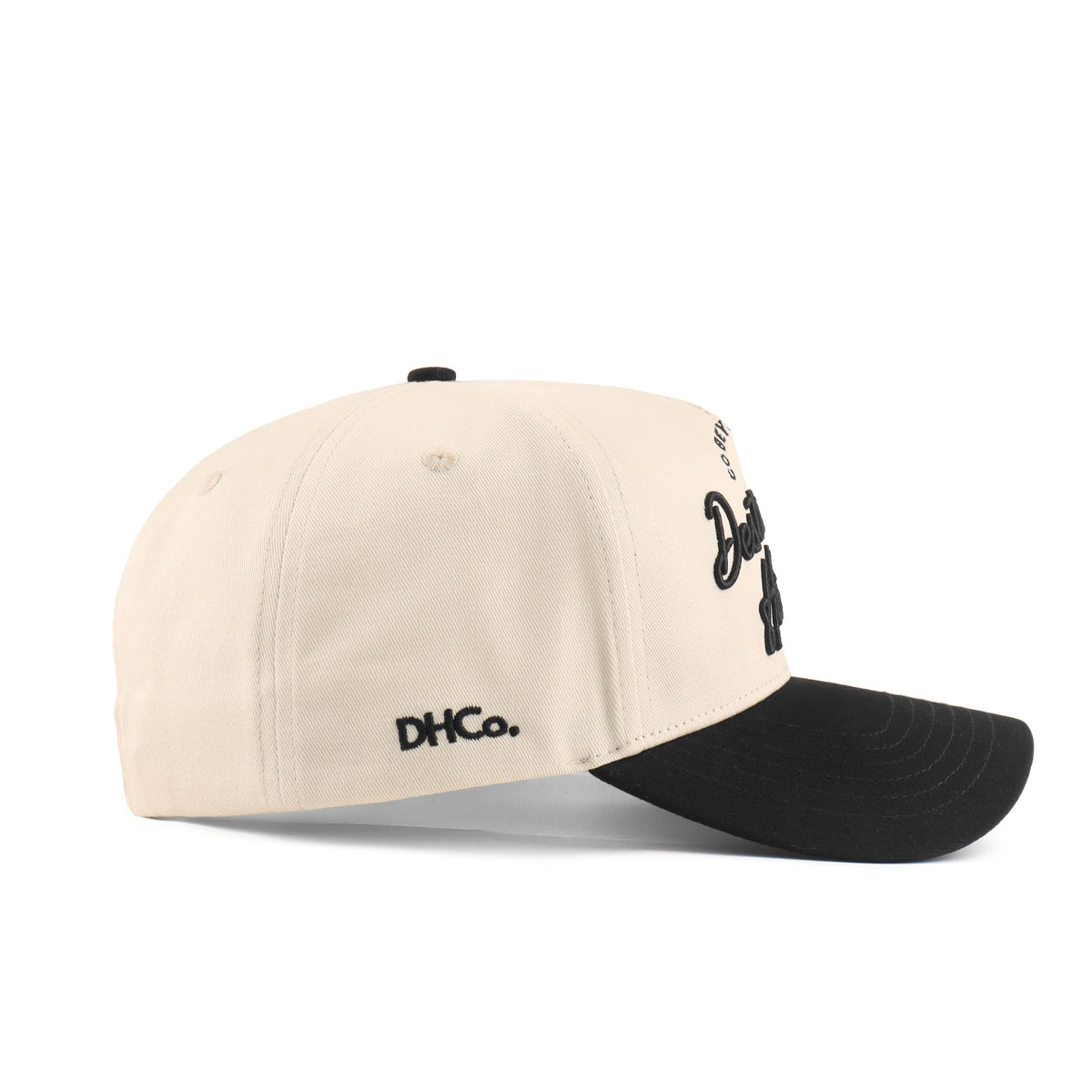 Side profile of the Destination Hat Co. Baton Rouge script cap showing the curved bill and side logo