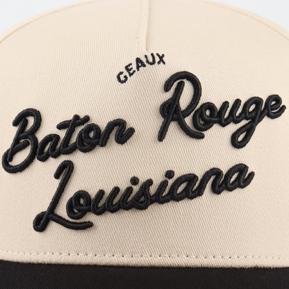Close-up of the black Baton Rouge embroidery on the beige crown