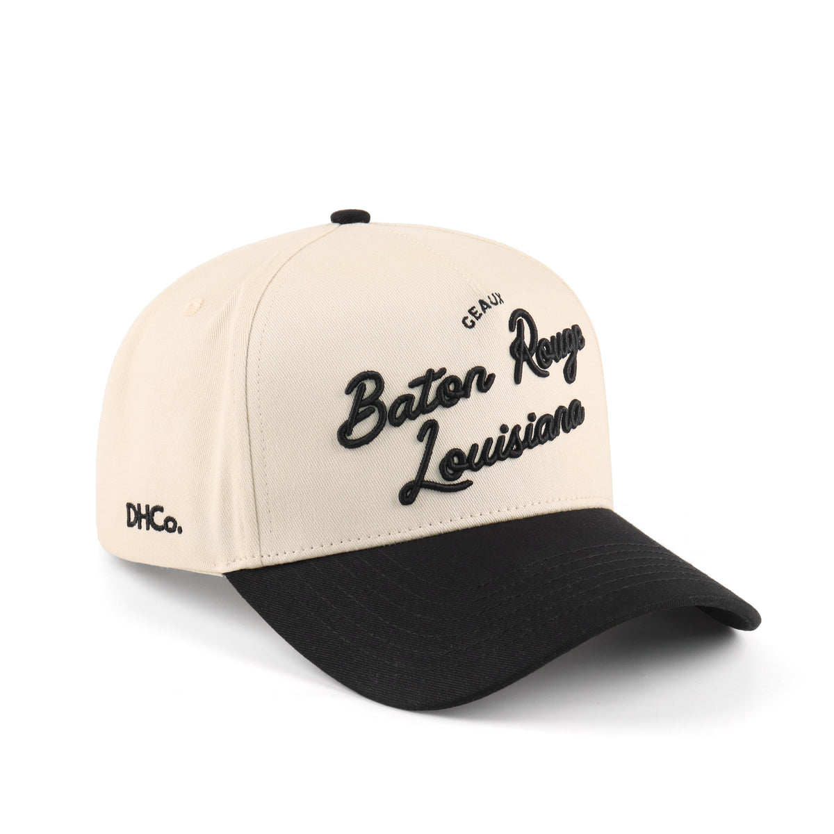 Destination Hat Co. Baton Rouge script cap with beige crown and black bill, angled view