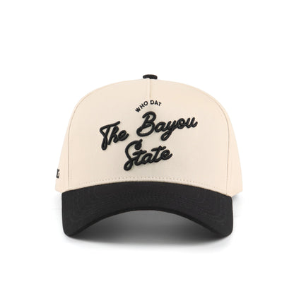 Front view of the Destination Hat Co. Bayou script cap with black embroidery