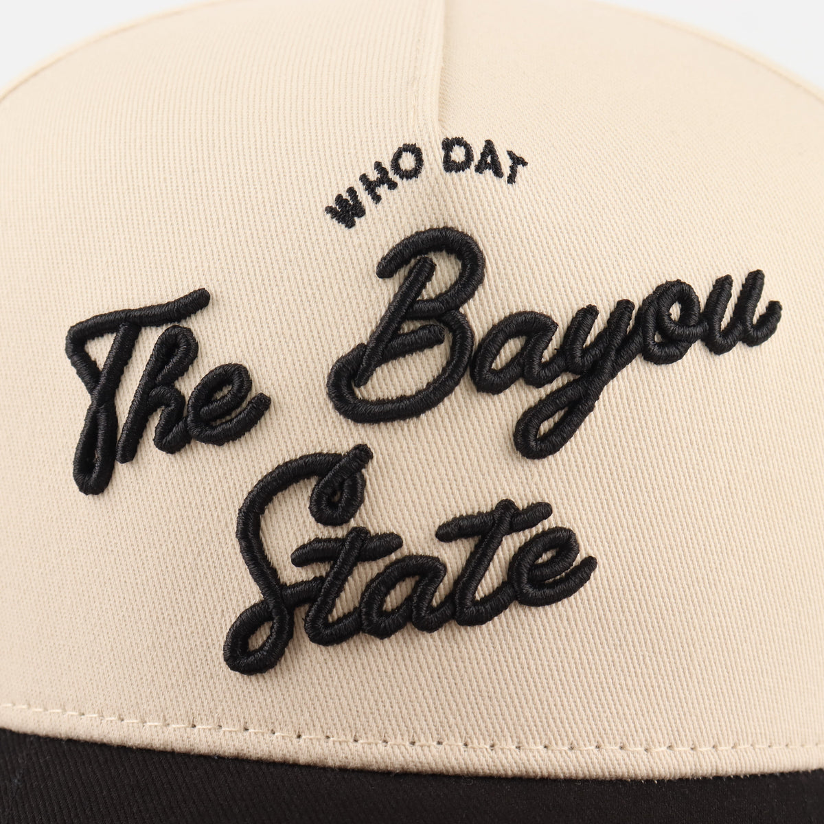 Close-up of the black Bayou embroidery on the beige crown
