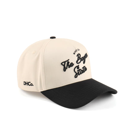 Destination Hat Co. Bayou script cap photographed from another angle with the full curved bill visible