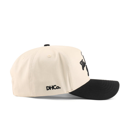 Side profile of the Destination Hat Co. Bayou script cap showing the curved bill and side logo
