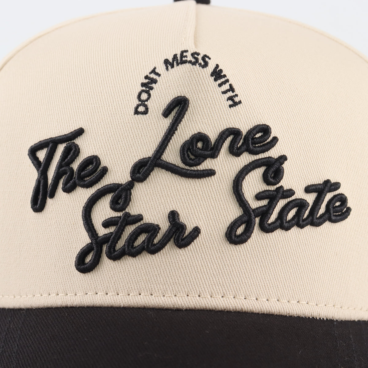Close-up of the black Lone Star embroidery on the beige crown