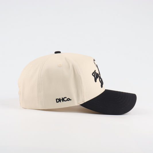 Side profile of the Destination Hat Co. Lone Star script cap showing the curved bill and side logo