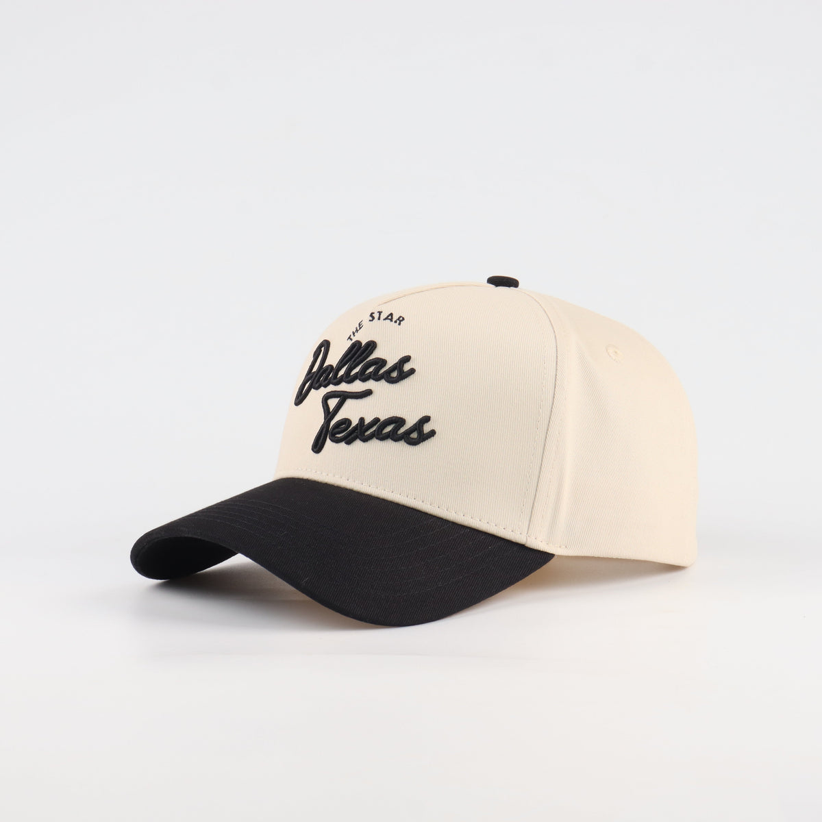 Opposite angled view of the Destination Hat Co. Dallas script cap showing the black lettering