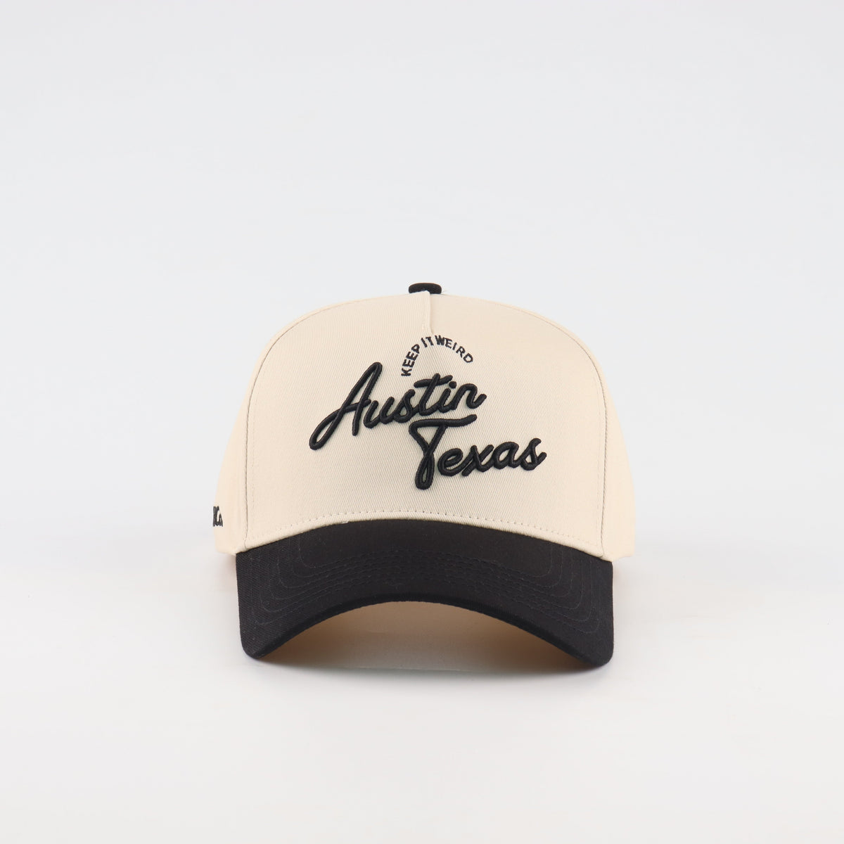 Front view of the Destination Hat Co. Austin script cap with black embroidery